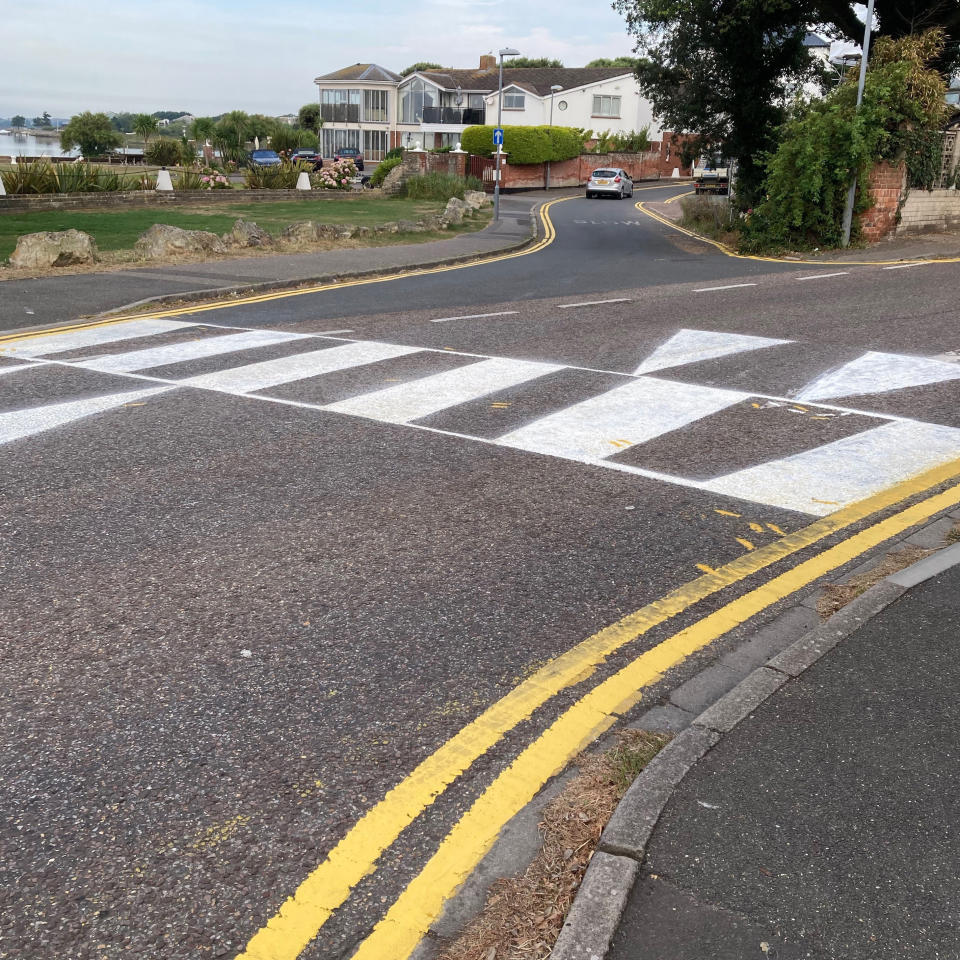 A man in the UK has painted a crossing on his road to help out his disabled wife. Source: Bournemouth News/Australscope