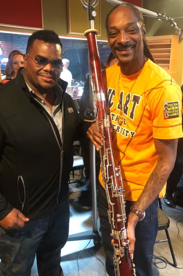 Anthony Parnther, left, with Snoop Dogg and the bassoon that was stolen from Parnther last week.