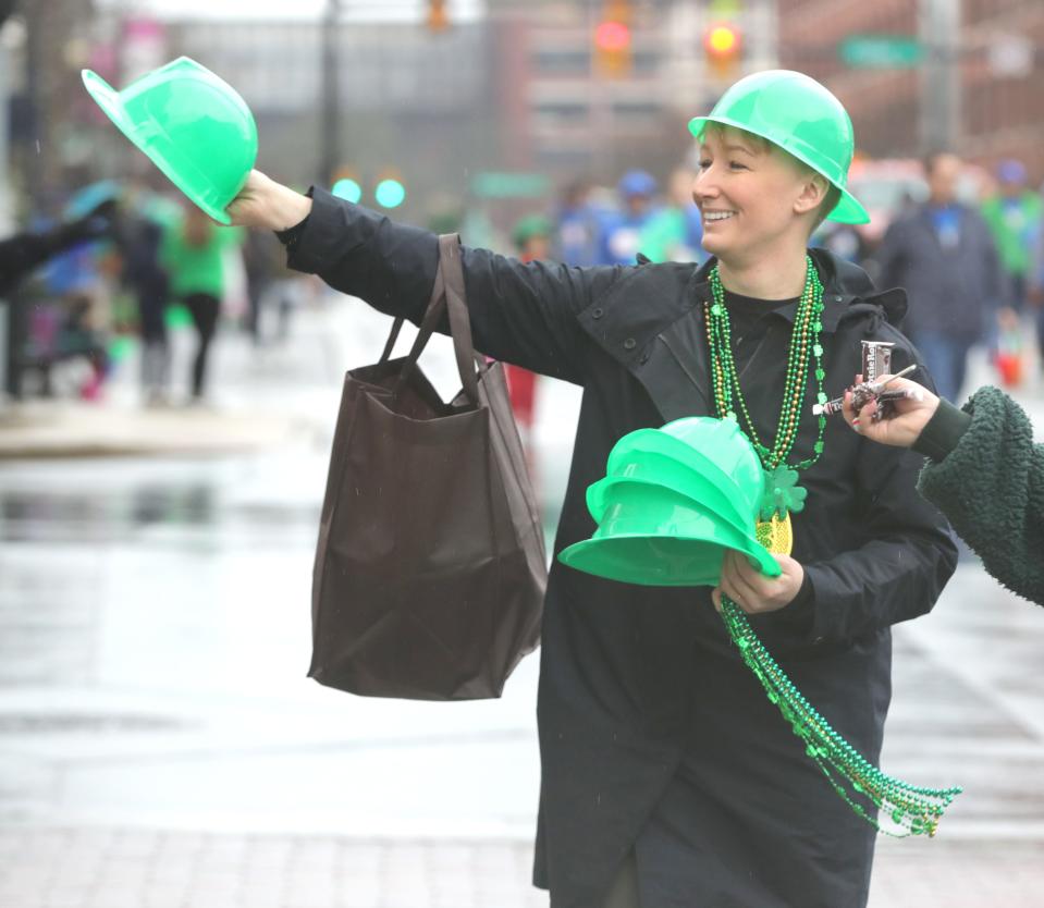 Akron city prosecutor Jess Connell passes out hats during the St. Patrick's Day Parade in downtown Akron March 9. Various other holiday events will be happening in the city this upcoming weekend.