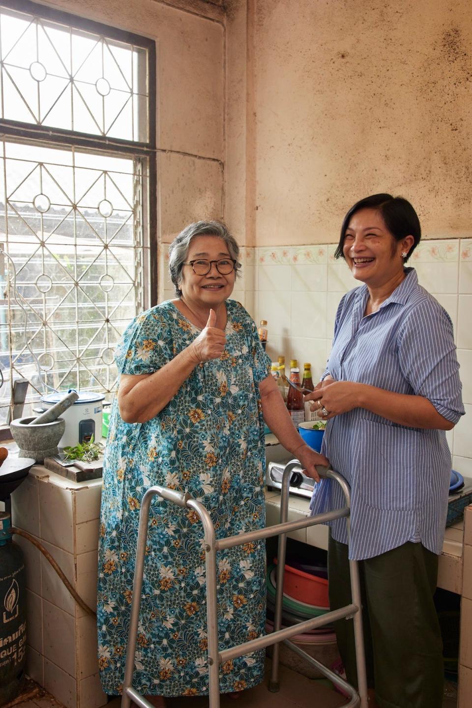 Chef Chutatip "Nok" Suntaranon and her mother Kalaya pose for a photo while cooking in the kitchen.