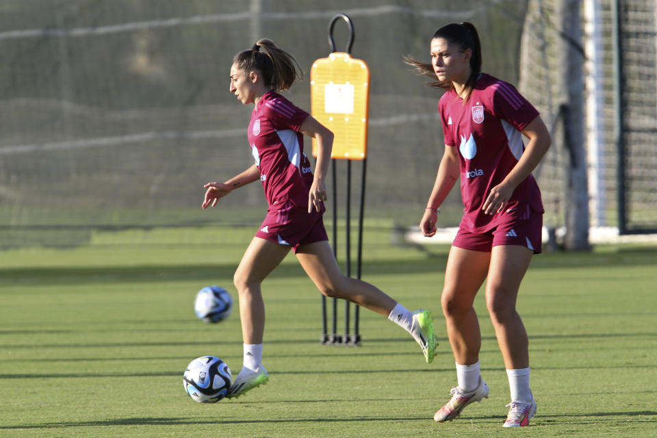 Spain's Olga Carmona, left, runs with the ball during a training session in Oliva, Spain, Wednesday, Sept. 20, 2023. Most of Spain's World Cup-winning players have ended their boycott of the women's national team after the government intervened to help shape an agreement that was expected to lead to immediate structural changes at the country's soccer federation. (AP Photo/Alberto Saiz)