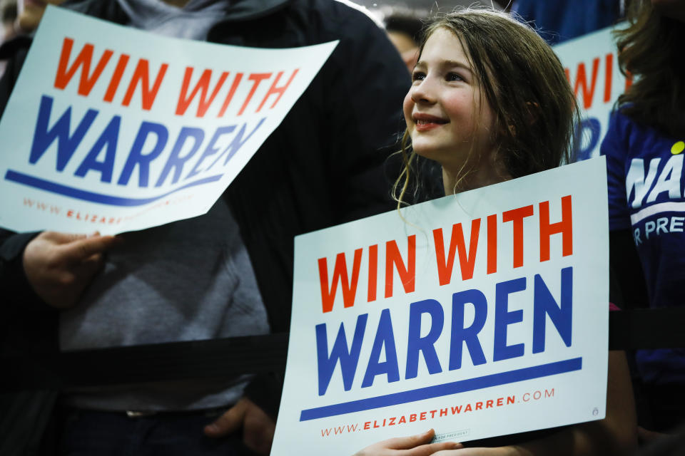 Attendees listen to Democratic presidential candidate Sen. Elizabeth Warren, D-Mass., speak during a campaign event at Rundlett Middle School, Sunday, Feb. 9, 2020, in Concord, N.H. (AP Photo/Matt Rourke)