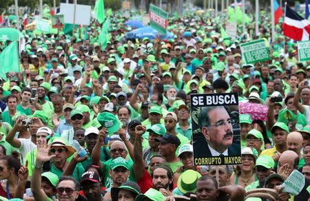 People march during a protest against corruption and the Brazilian conglomerate Odebrecht SA, in Santo Domingo, Dominican Republic, July 16, 2017. The sign reads "Wanted corrupt senior" REUTERS/Ricardo Rojas