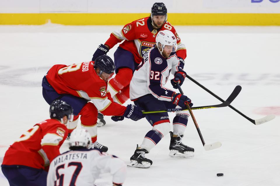 Apr 11, 2024; Sunrise, Florida, USA; Columbus Blue Jackets left wing Alexander Nylander (92) moves the puck past Florida Panthers right wing Kyle Okposo (8) during the first period at Amerant Bank Arena. Mandatory Credit: Sam Navarro-USA TODAY Sports