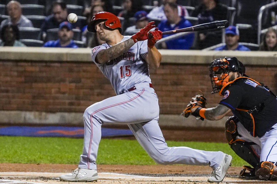 Cincinnati Reds' Nick Senzel, left, fouls a pitch during the first inning of a baseball game against the New York Mets, Friday, Sept. 15, 2023, in New York. (AP Photo/Bebeto Matthews)