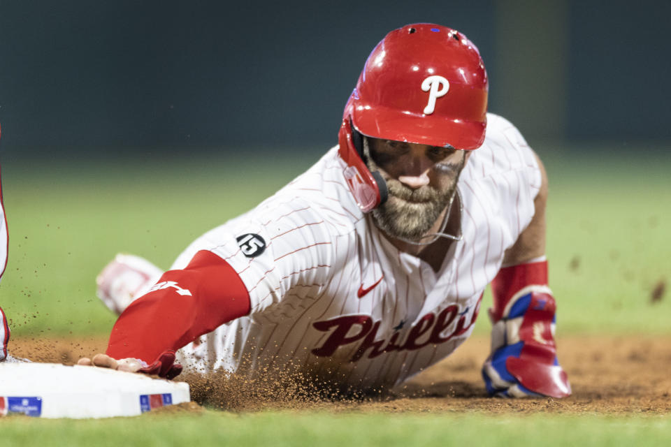 Philadelphia Phillies' Bryce Harper is safe on a pickoff-attempt at first base during the seventh inning of a baseball game against the Washington Nationals, Monday, July 26, 2021, in Philadelphia. (AP Photo/Laurence Kesterson)