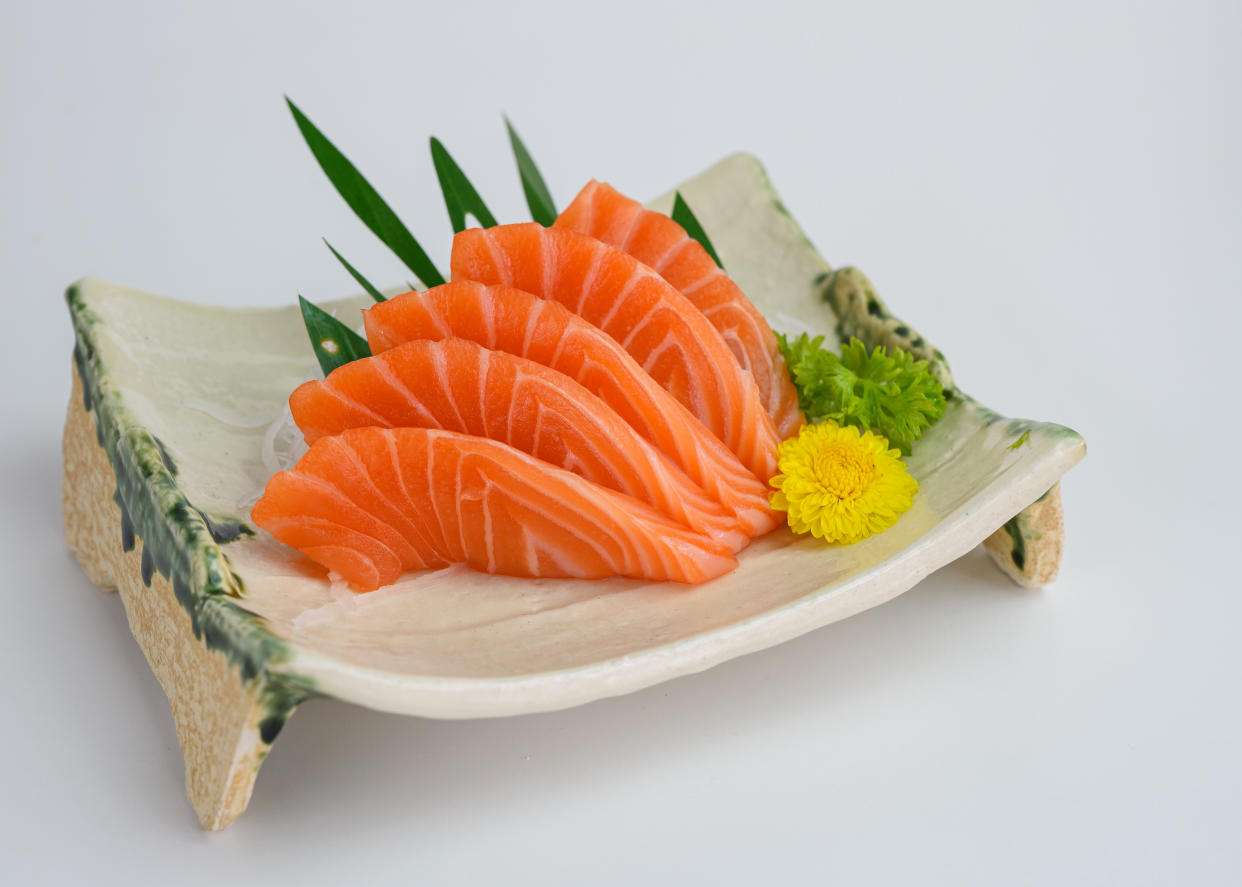 Sliced raw Salmon sashimi on ceramic plate