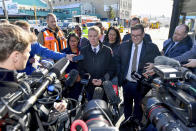 New Zealand Prime Minister Chris Hipkins, center, speaks to media near the site of a fatal hostel fire in Wellington, New Zealand, Tuesday, May 16, 2023. Several people were killed after a fire broke out overnight at the four-story building. (Masanori Udagawa/AAP Image via AP)