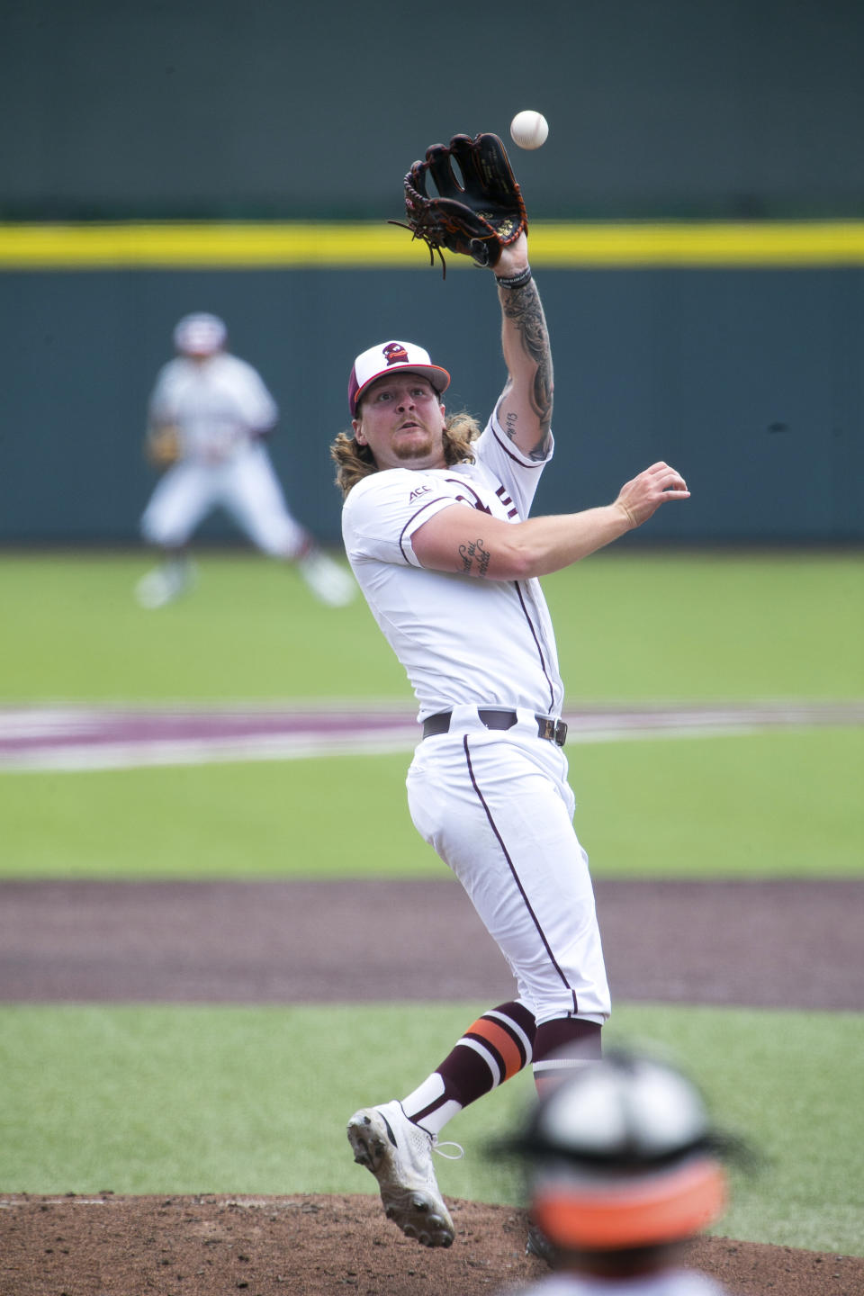 Virginia Tech's Jordan Geber (30) reaches for a ball hit by Oklahoma in the second inning of an NCAA college baseball super regional game, Sunday, June 12, 2022, in Blacksburg, Va. (AP Photo/Scott P. Yates)