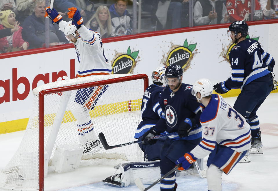 Edmonton Oilers' Leon Draisaitl (29) celebrates his goal against the Winnipeg Jets during second period of NHL hockey game in Winnipeg, Manitoba, Saturday, March 4, 2023. (John Woods/The Canadian Press via AP)