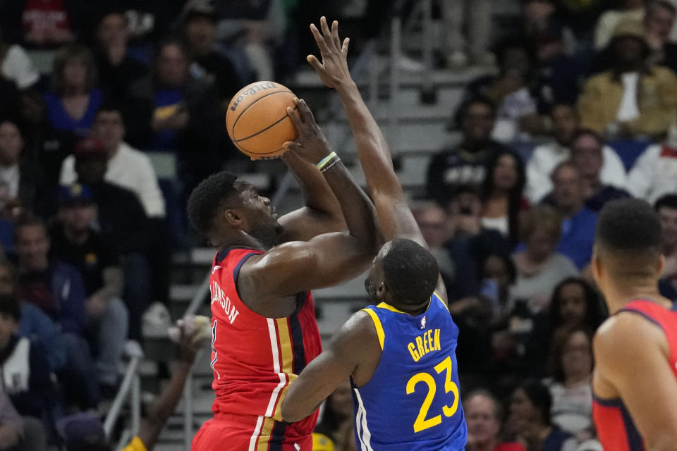 New Orleans Pelicans forward Zion Williamson (1) shoots against Golden State Warriors forward Draymond Green (23) in the first half of an NBA basketball game in New Orleans, Monday, Oct. 30, 2023. (AP Photo/Gerald Herbert)