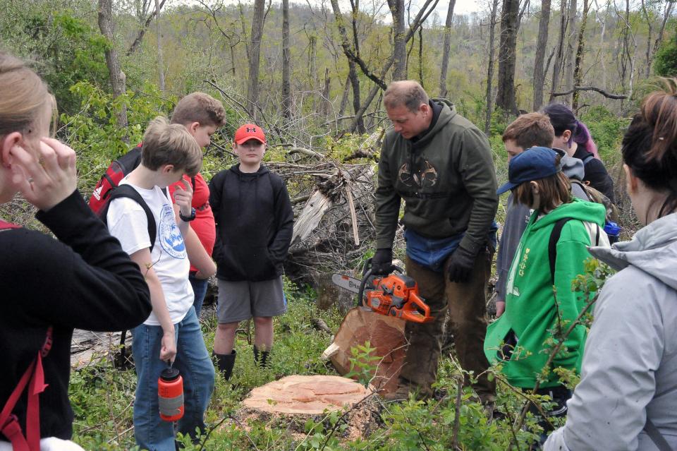 Devon Miller cut down a damaged tree so students could learn about counting tree rings to find the age of a tree. Wooster's Edgewood Middle School seventh graders spent time in the Killbuck marsh planting trees and cleaning storm debris as part of a science project.
