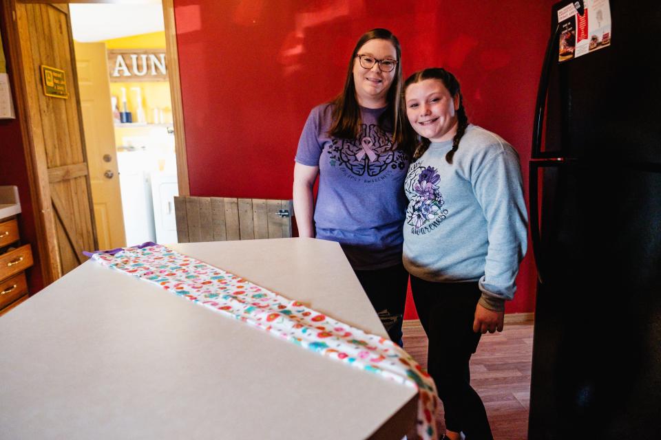 Heather Slemmer and her daughter, Sofia, 10, at their home in Sugarcreek. Sophia has epilepsy and uses a special head covering called a NillyNoggin when at the hospital for an EEG, or electroencephalogram.