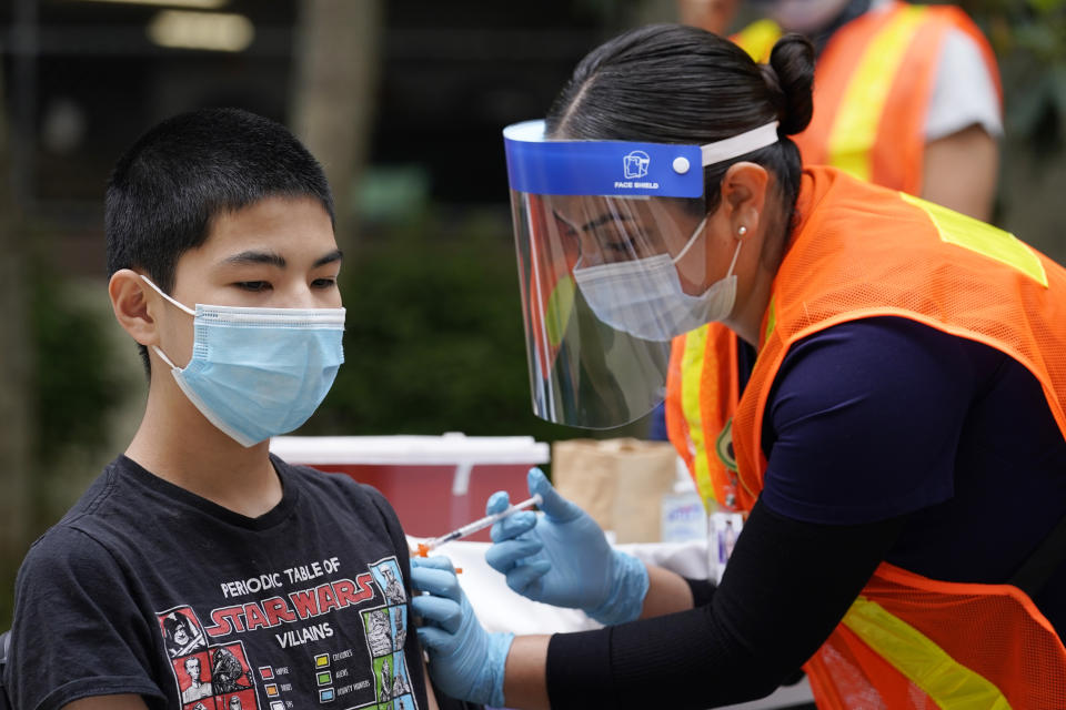 Noah Chen, 13, gets a shot of the Pfizer COVID-19 vaccine at the First Baptist Church of Pasadena, Friday, May 14, 2021, in Pasadena, Calif. (AP Photo/Marcio Jose Sanchez)