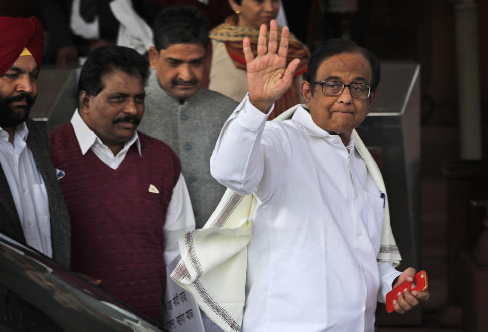 Indian lawmaker and former Finance Minister Palaniappan Chidambaram waves as he arrives at the Parliament House for a protest against the rise in onion prices, in New Delhi, India, Thursday, Dec. 5, 2019. Chidambaram, just released on bail in a bribery case, has joined a protest of the government's economic policies, which are being blamed for India's slowest economic growth in six years. (AP Photo/Manish Swarup)