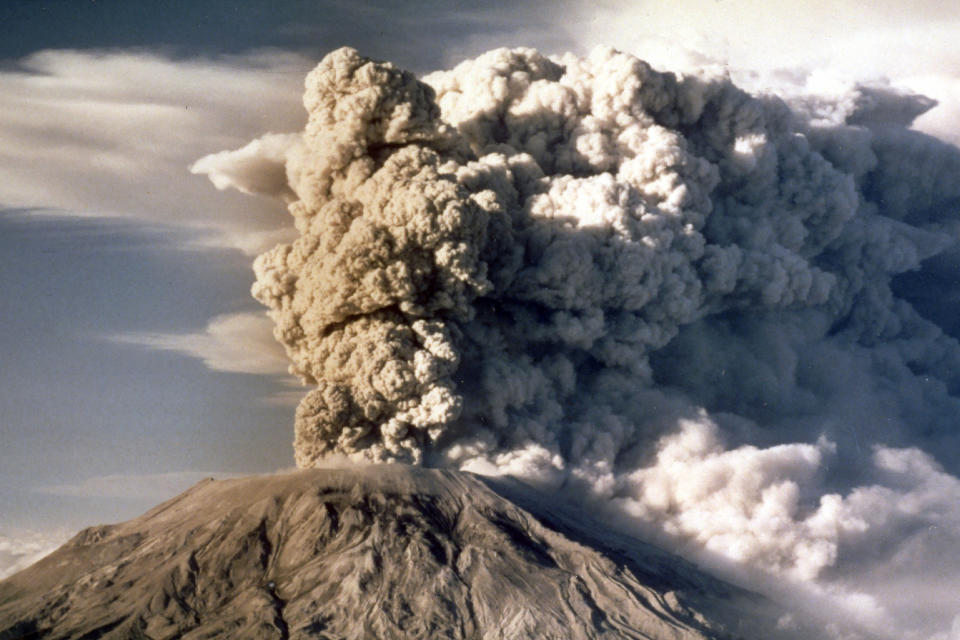 FILE - Mount St. Helens in Washington spews smoke, soot and ash into the sky in April 1980. Jack Smith, an AP photographer who captured unforgettable shots of the eruption of Mount St. Helens, the Exxon-Valdez oil spill, the Olympics and many other events during his 35-year career with the news organization, passed away on Jan. 4, 2023, at his home in La Mesa, Calif. He was 80. (AP Photo/Jack Smith, File)