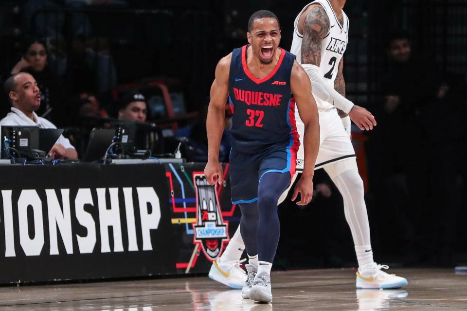Mar 17, 2024; Brooklyn, NY, USA; Duquesne Dukes guard Kareem Rozier (32) celebrates after making a three point shot in the first half against the Virginia Commonwealth Rams at Barclays Center. Mandatory Credit: Wendell Cruz-USA TODAY Sports