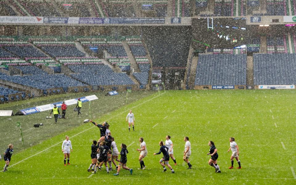 Scotland's Emma Wassell wins the ball in a line out as heavy snow falls - PA