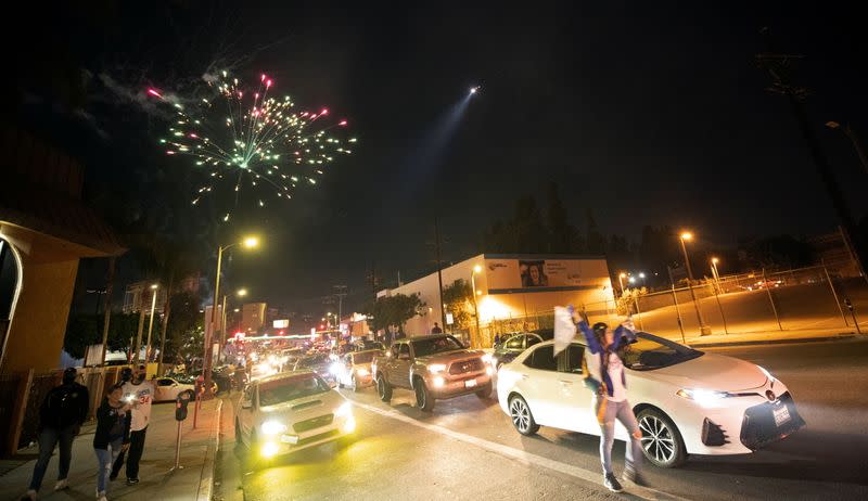 People celebrate Los Angeles Dodgers' victory at the end of game 6 of the 2020 World Series between Los Angeles Dodgers and Tampa Bay Rays, amidst the outbreak of the coronavirus disease (COVID-19), in Los Angeles