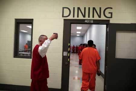 ICE detainees walk into the dining area for lunch at the Adelanto immigration detention center, which is run by the Geo Group Inc (GEO.N), in Adelanto, California, U.S., April 13, 2017. REUTERS/Lucy Nicholson
