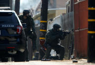 <p>A police SWAT team surround a home as they search for a second suspect after a San Diego police officer was fatally shot and another was wounded late on Thursday, the police department said on Friday, adding one suspect was taken into custody in San Diego, Calif., on July 29, 2016. (REUTERS/Mike Blake)</p>