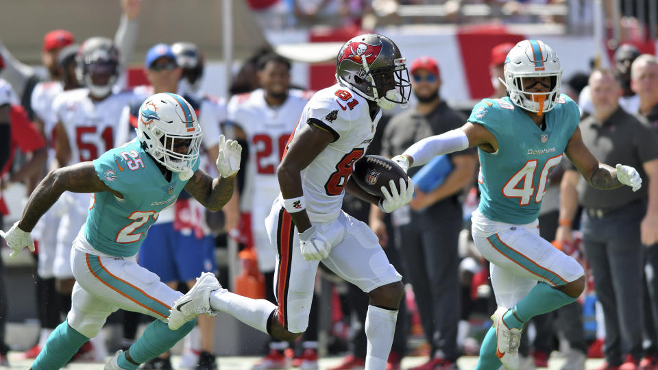 Tampa Bay Buccaneers wide receiver Antonio Brown (81) beats Miami Dolphins cornerback Xavien Howard (25) and free safety Nik Needham (40) on a 62-yard touchdown reception from quarterback Tom Brady during the first half of an NFL football game Sunday, Oct. 10, 2021, in Tampa, Fla. (AP Photo/Jason Behnken)