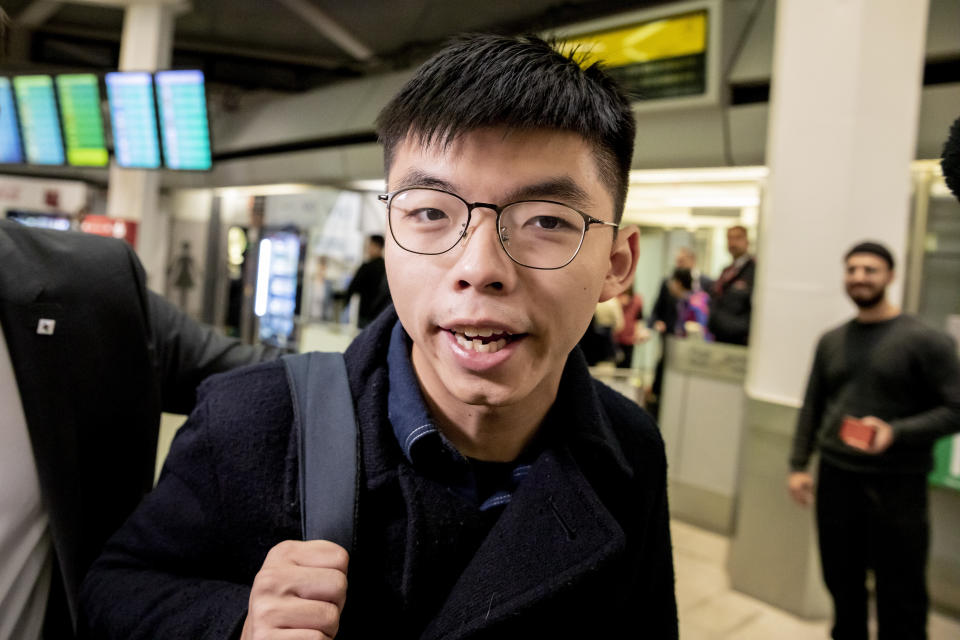 Hong Kong activist Joshua Wong carries a bag as he arrives at the Tegel Airport in Berlin, Germany, Monday, Sept. 9, 2019. Wong will address the media during a press conference in Berlin on Wednesday, Sept. 11, 2019. (Christoph Soeder/dpa via AP)