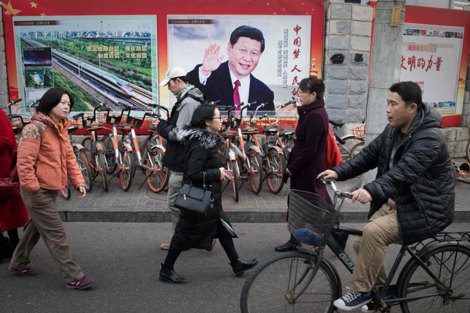 File: A propaganda poster showing China’s President Xi Jinping is pictured on a wall in Beijing (AFP via Getty Images)