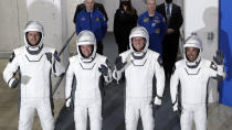 The Crew Dragon space capsule astronauts, from front left, European Space Agency astronaut Thomas Pesquet, NASA astronaut Megan McArthur, NASA astronaut Shane Kimbrough and Japan Aerospace Exploration Agency astronaut Akihiko Hoshide leave the Operation and Checkout Building on their way to board the capsule for a mission to the International Space Station at the Kennedy Space Center in Cape Canaveral, Fla., Friday, April 23, 2021. (AP Photo/John Raoux)