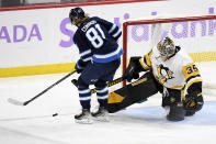 Pittsburgh Penguins goaltender Tristan Jarry (35) makes a save on Winnipeg Jets' Kyle Connor (81) during the third period of an NHL hockey game Monday, Nov. 22, 2021, in Winnipeg, Manitoba. (Fred Greenslade/The Canadian Press via AP)