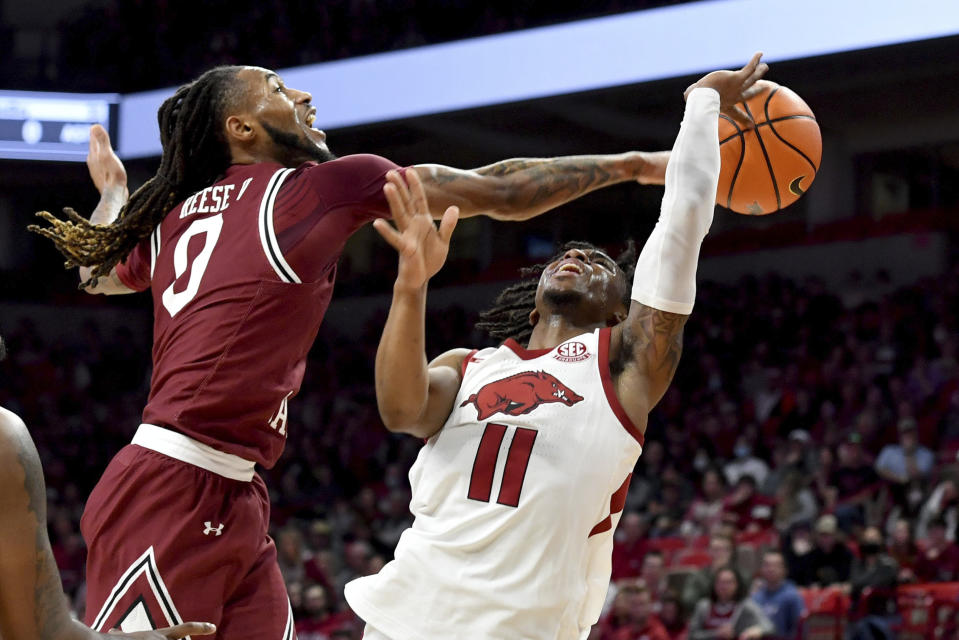 South Carolina guard James Reese V (0) knocks the ball away from Arkansas guard Chris Lykes (11) during the first half of an NCAA college basketball game Tuesday, Jan. 18, 2022, in Fayetteville, Ark. (AP Photo/Michael Woods)