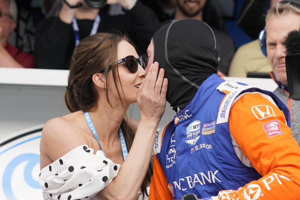 Scott Dixon, of New Zealand, gets a kiss from his wife, Emma Davies, after winning the pole during qualifications for the Indianapolis 500 auto race at Indianapolis Motor Speedway, Sunday, May 22, 2022, in Indianapolis. (AP Photo/Darron Cummings)