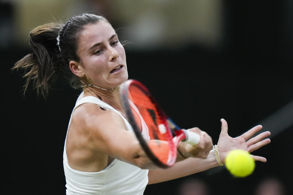 Emma Navarro of the United States plays a forehand return to compatriot Coco Gauff during their fourth round match at the Wimbledon tennis championships in London, Sunday, July 7, 2024. (AP Photo/Alberto Pezzali)
