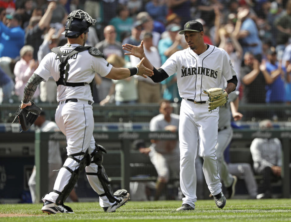 Seattle closer Edwin Diaz, right, greets catcher Mike Zunino after the Mariners beat the Texas Rangers in a May game. (AP)