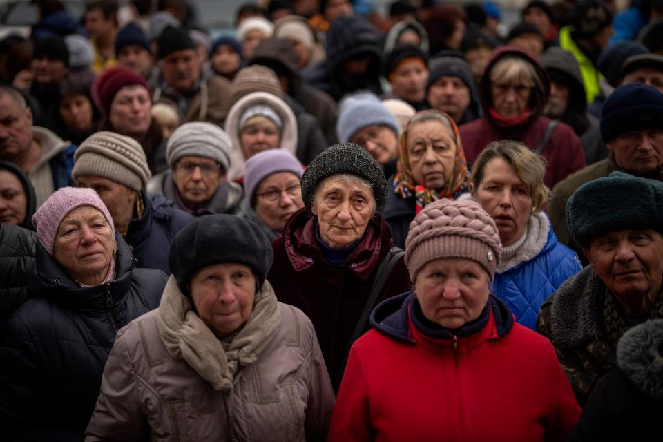 Ukrainians wait for a food distribution organized by the Red Cross in Bucha (Copyright 2022 The Associated Press. All rights reserved.)