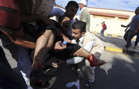 ATTENTION EDITORS - VISUAL COVERAGE OF SCENES OF INJURY OR DEATH People carry a man who was injured when Libyan militiamen opened fire into a crowd of protesters in Tripoli November 15, 2013. REUTERS/Stringer