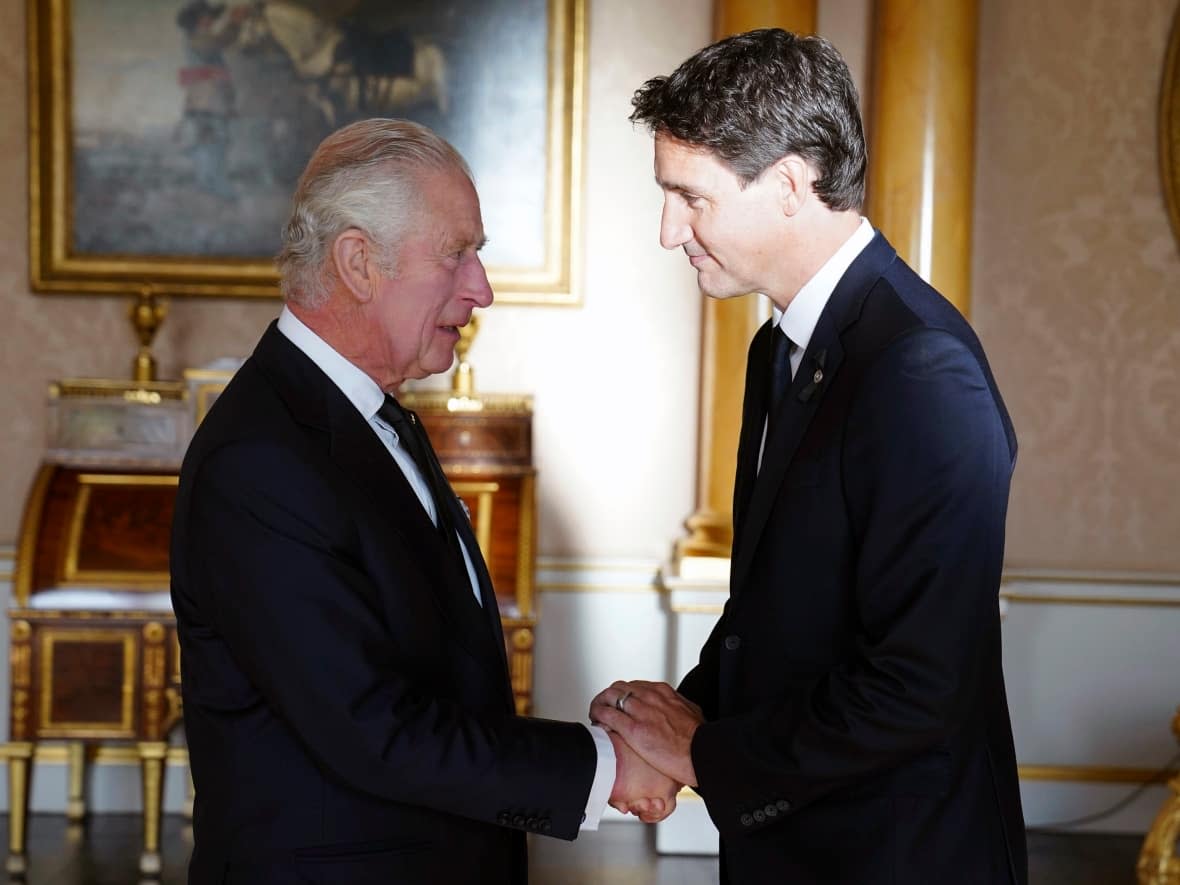 King Charles shakes hands with Prime Minister Justin Trudeau at Buckingham Palace in London on Sept. 17, 2022. Monarchists say they fear the federal government may have nothing planned for Charles's coronation in May. (Stefan Rousseau/The Associated Press - image credit)