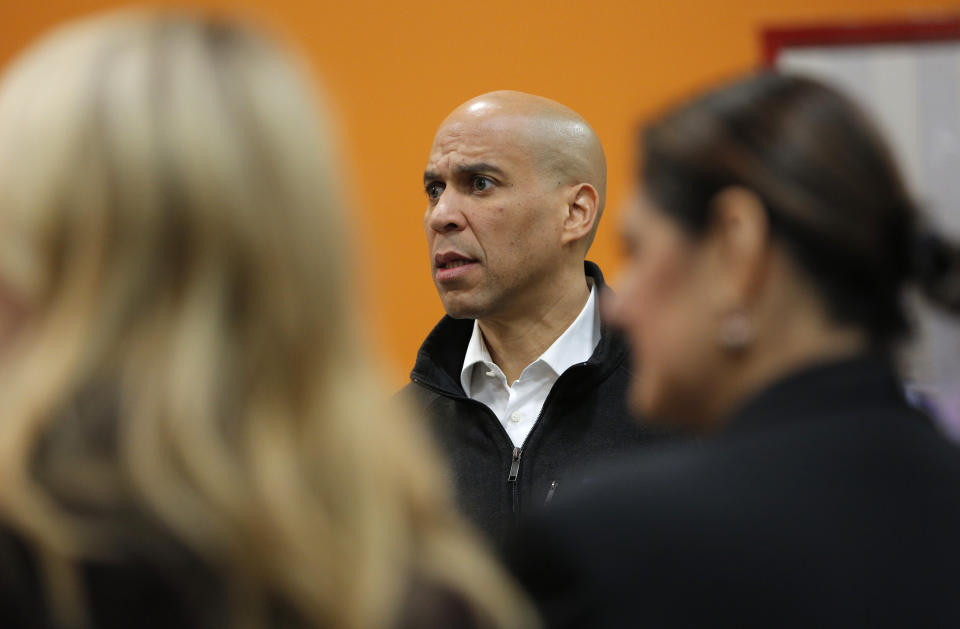 Democratic presidential candidate Sen. Cory Booker, center, D-N.J., tours the Three Square food bank Thursday, Dec. 19, 2019, in Las Vegas. (AP Photo/John Locher)