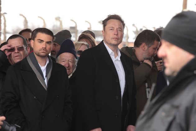 Tesla and SpaceX's CEO Elon Musk, center, walks during his visit to the site of the Auschwitz-Birkenau Nazi German death camp in Oswiecim, Poland, on Monday, Jan. 22, 2024. (AP Photo/Andrzej Rudiak)
