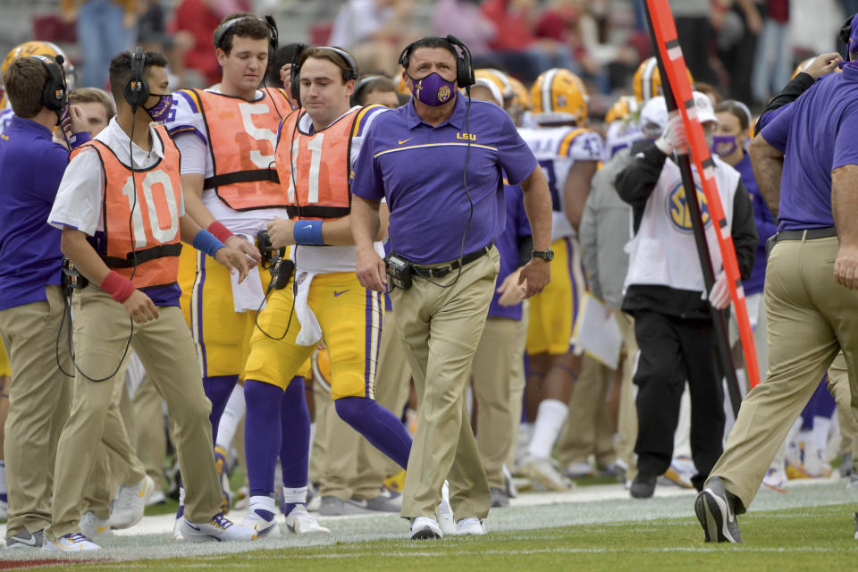 LSU coach Ed Orgeron walks on the sidelines against Arkansas during the second half of an NCAA college football game Saturday, Nov. 21, 2020, in Fayetteville, Ark. (AP Photo/Michael Woods)