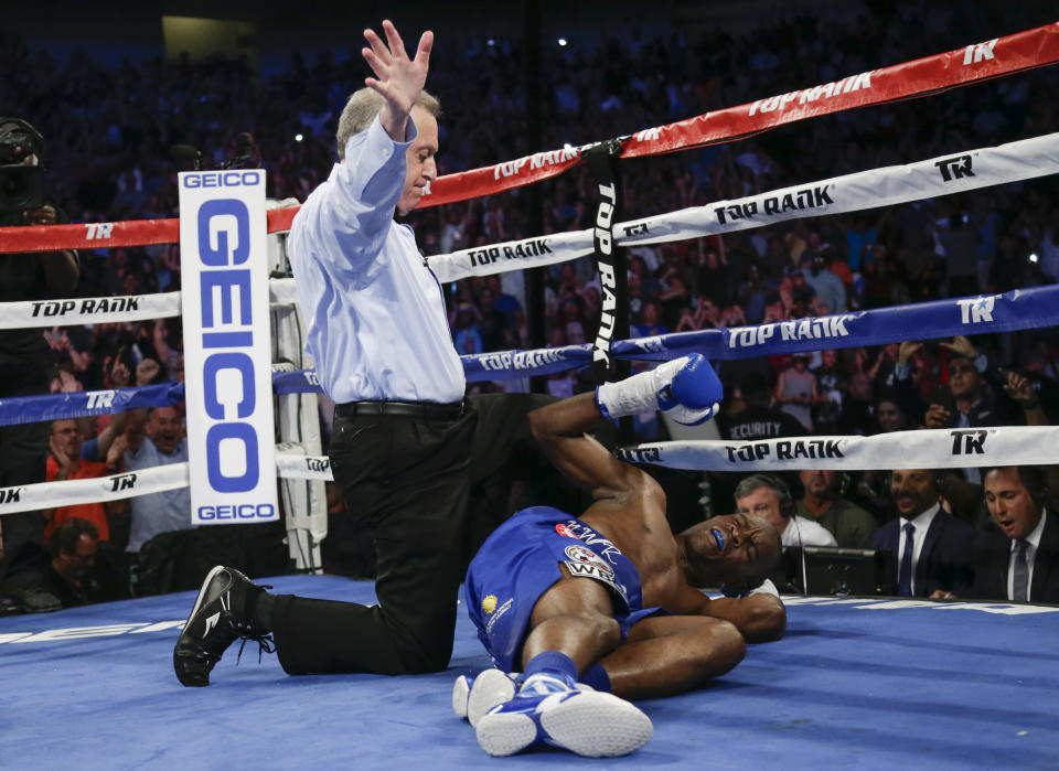 Referee Jack Reiss counts out Julius Indongo, who was knocked out by Terence Crawford Saturday in the third round of the IBF-WBA-WBC-WBO super lightweight unification bout. (The Associated Press)