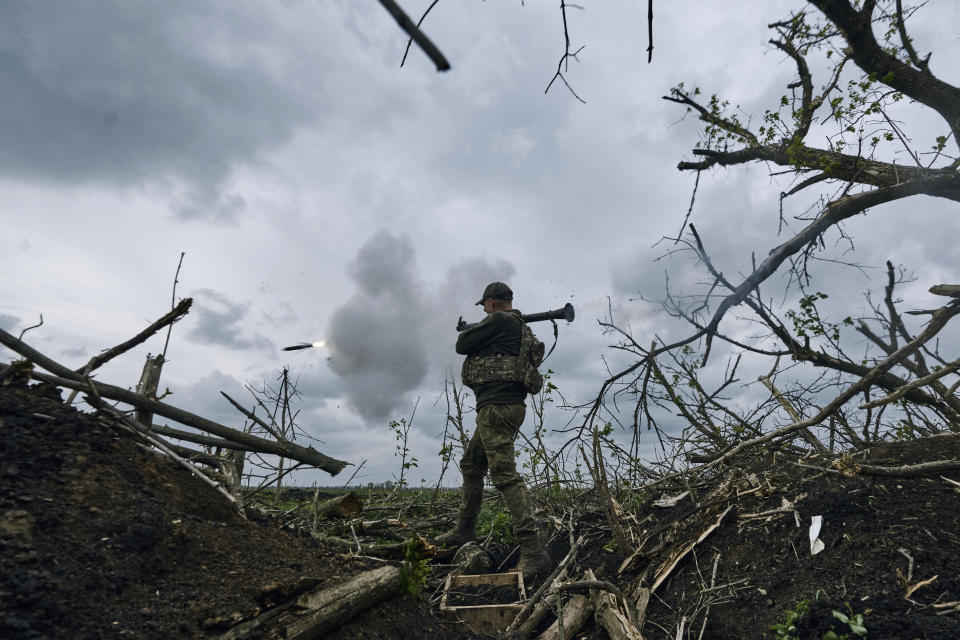 A Ukrainian soldier fires an RPG toward Russian positions at the frontline near Avdiivka, an eastern city where fierce battles against Russian forces have been taking place, in the Donetsk region, Ukraine, Friday, April 28, 2023. (AP Photo/Libkos)