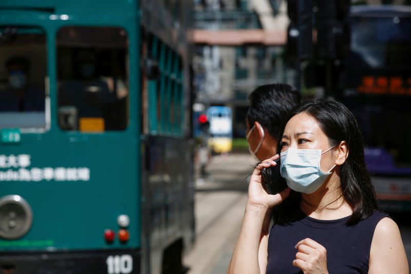 FILE PHOTO: A woman wears a surgical mask following the coronavirus disease (COVID-19) outbreak, in Hong Kong