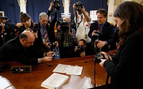 Photographers take shots of the articles of impeachment approved by the House Judiciary Committee  - Credit: AP Photo/Patrick Semansky