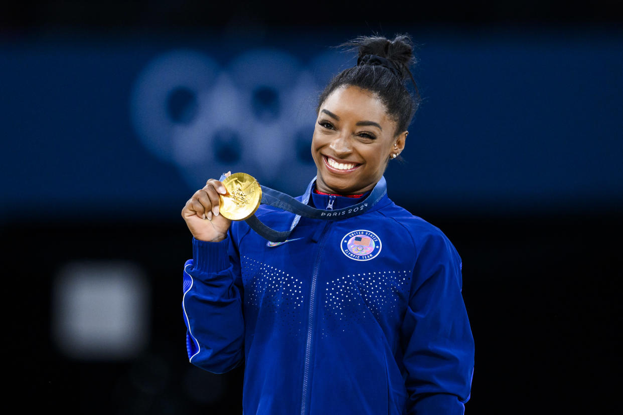 PARIS, FRANCE - AUGUST 3: Gold mealist Simone Biles of Team United States celebrates on the podium during the medal ceremony for the Artistic Gymnastics Women's Vault Final on day eight of the Olympic Games Paris 2024 at the Bercy Arena on August 3, 2024 in Paris, France. (Photo by Tom Weller/VOIGT/GettyImages)