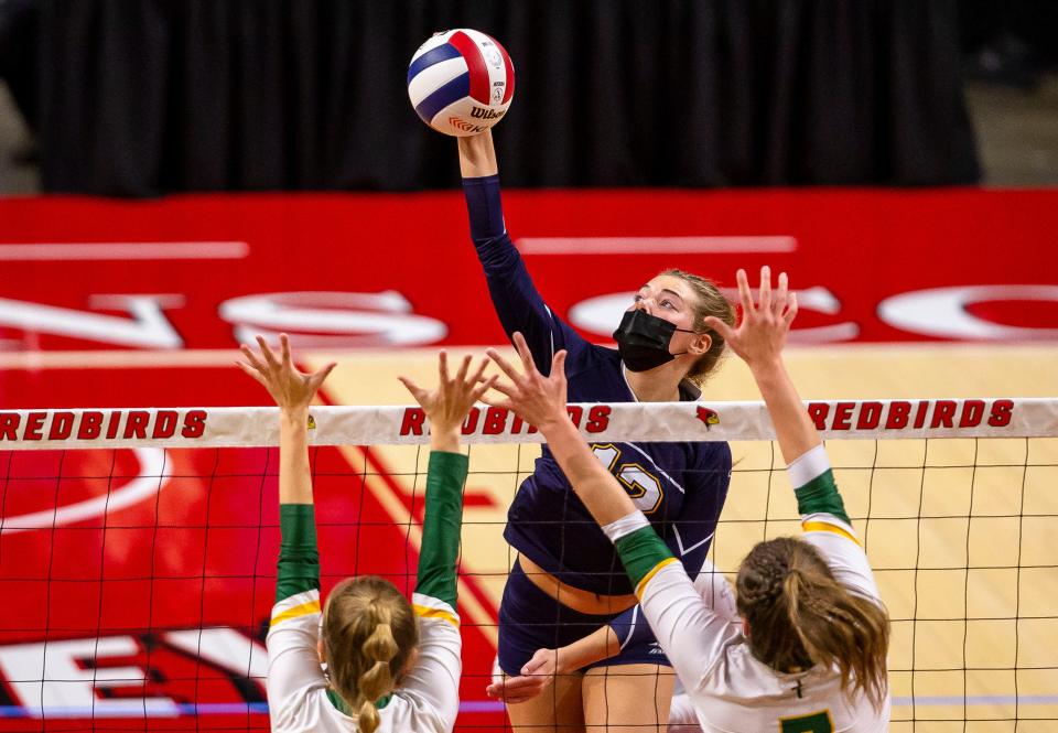 Freeport Aquin's Lucy Arndt (12) attempts a spike against  Champaign St. Thomas More during the semifinals of the IHSA Class 1A State Final Tournament at Redbird Arena in Normal, Ill., Friday, November 12, 2021. [Justin L. Fowler/The State Journal-Register] 