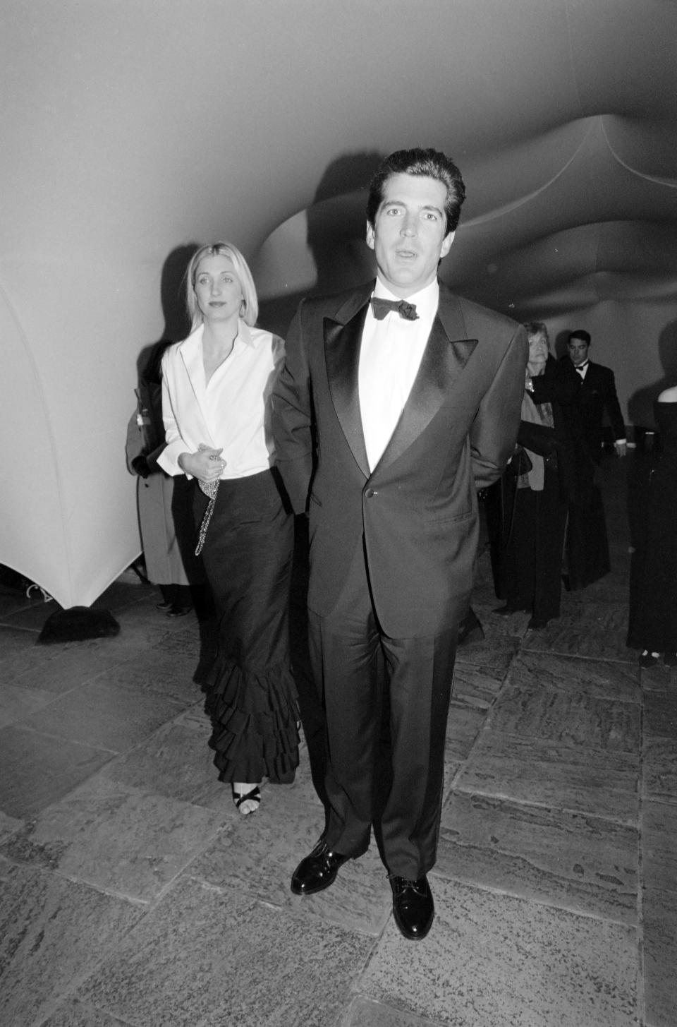 Carolyn Bessette-Kennedy, John F. Kennedy, Jr and guest attend a party at the Whitney Museum to celebrate the Exhibition "The American Century: Art & Culture 1900-2000." on March 11, 1999 in New York. (Photo by Steve Eichner/Penske Media via Getty Images)