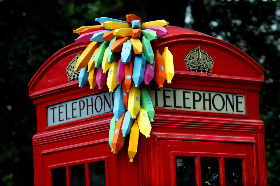 An installation of paper bananas attached to a public telephone box, created by Brazilian graphic artist Breno Pineschi as part of as part of the arts campaign 'Rio Occupation London', is seen in South Kensington