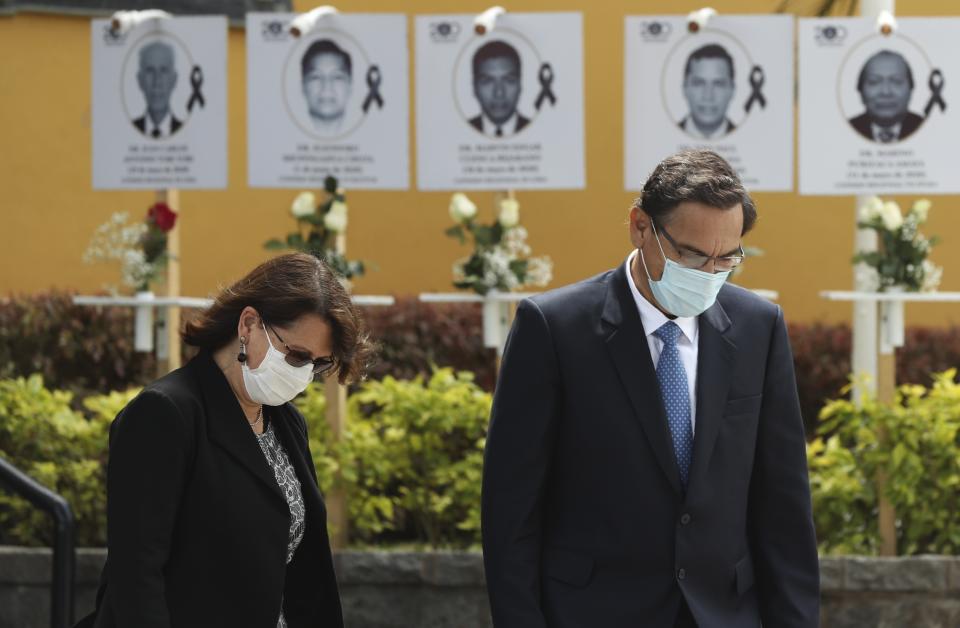 FILE - In this Aug. 13, 2020 file photo, Peru's President Martin Vizcarra and Minister of Health Pilar Mazzetti, attend a ceremony honoring doctors, pictured in the background, who died of the new coronavirus after treating infected patients, at the School of Medicine in Lima, Peru. In March, President Martin Vizcarra took the airwaves to announce he'd signed off on a massive purchase of 1.6 million tests – almost all of them for antibodies. Now experts say that decision is proving enormously costly. (AP Photo/Martin Mejia, File)