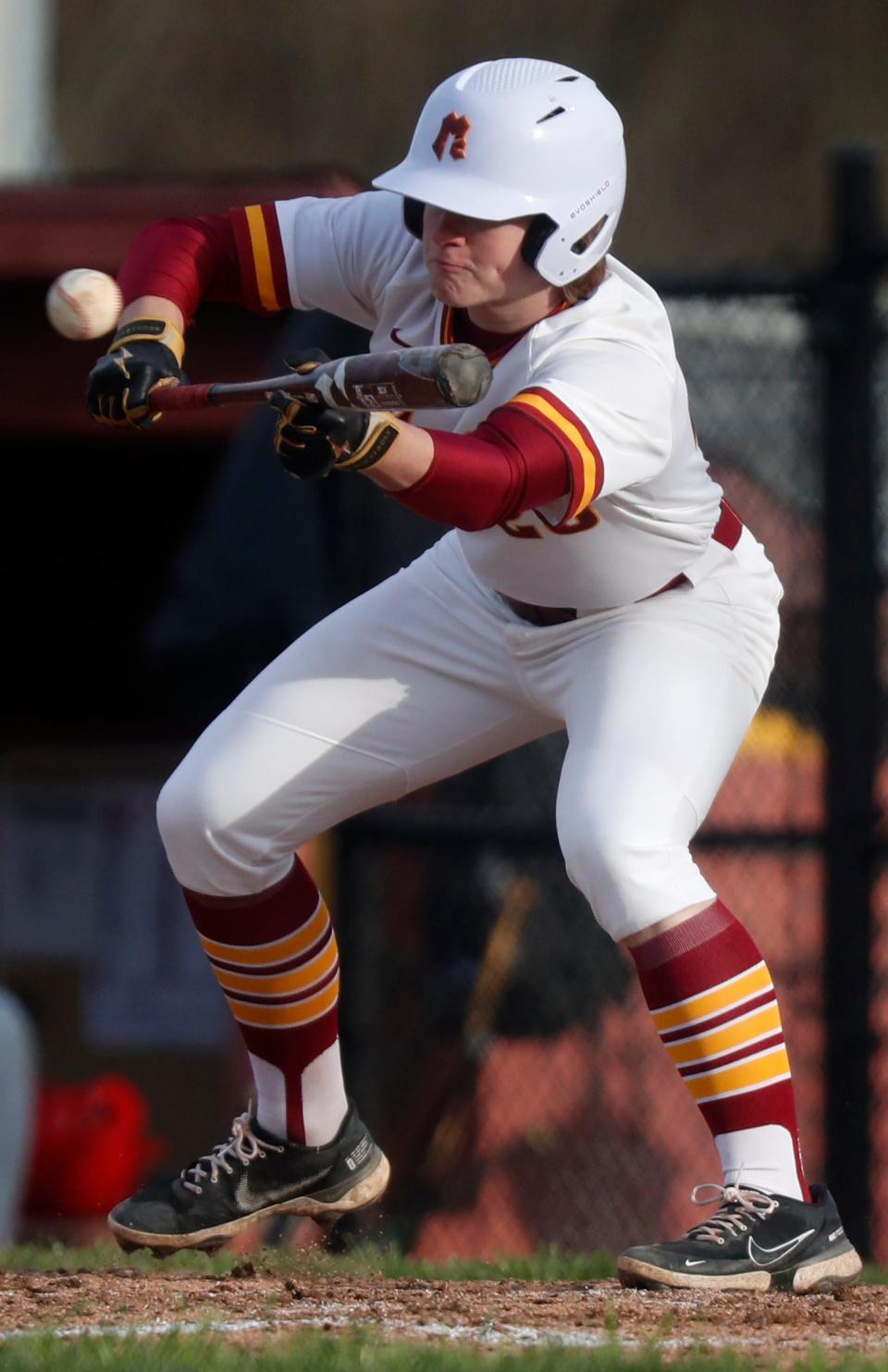 McCutcheon Mavericks Riley Sands (29) goes to bunt during the IHSAA baseball game against the West Lafayette Red Devils, Thursday, April 6, 2023, at the McCutcheon High School in Lafayette, Ind. 